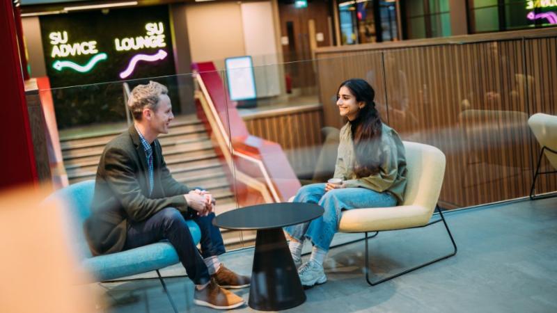 student talking to a mentor in One Elmwood student centre